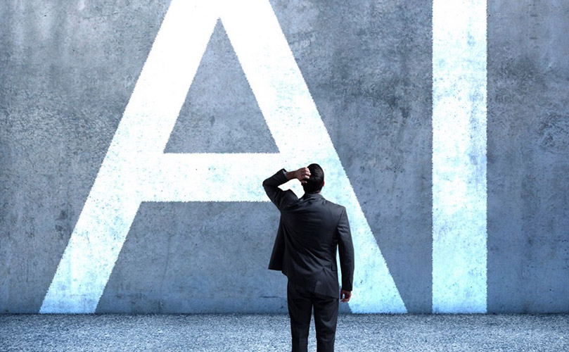 a man standing in front of a wall with the word AI on it