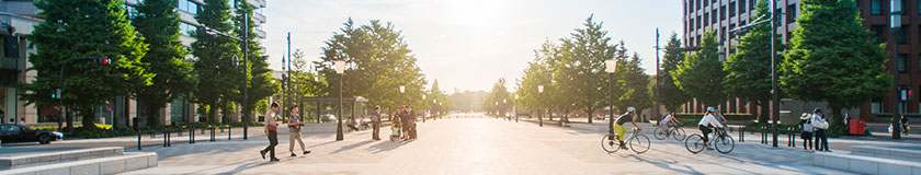 People and bicycles cross the main street of the business district